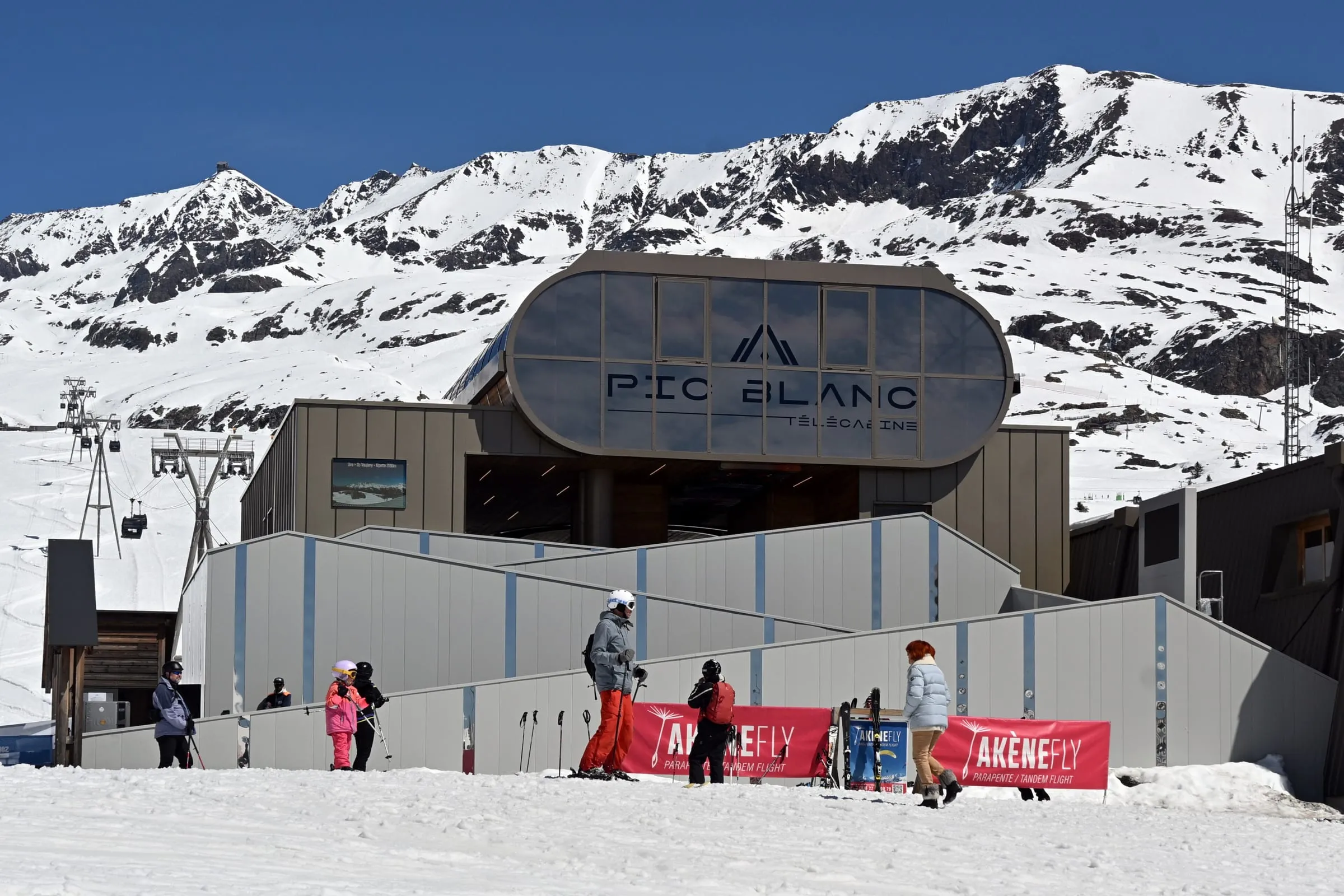 Skiers outside the Pic Blanc gondola station in Alpe d'Huez