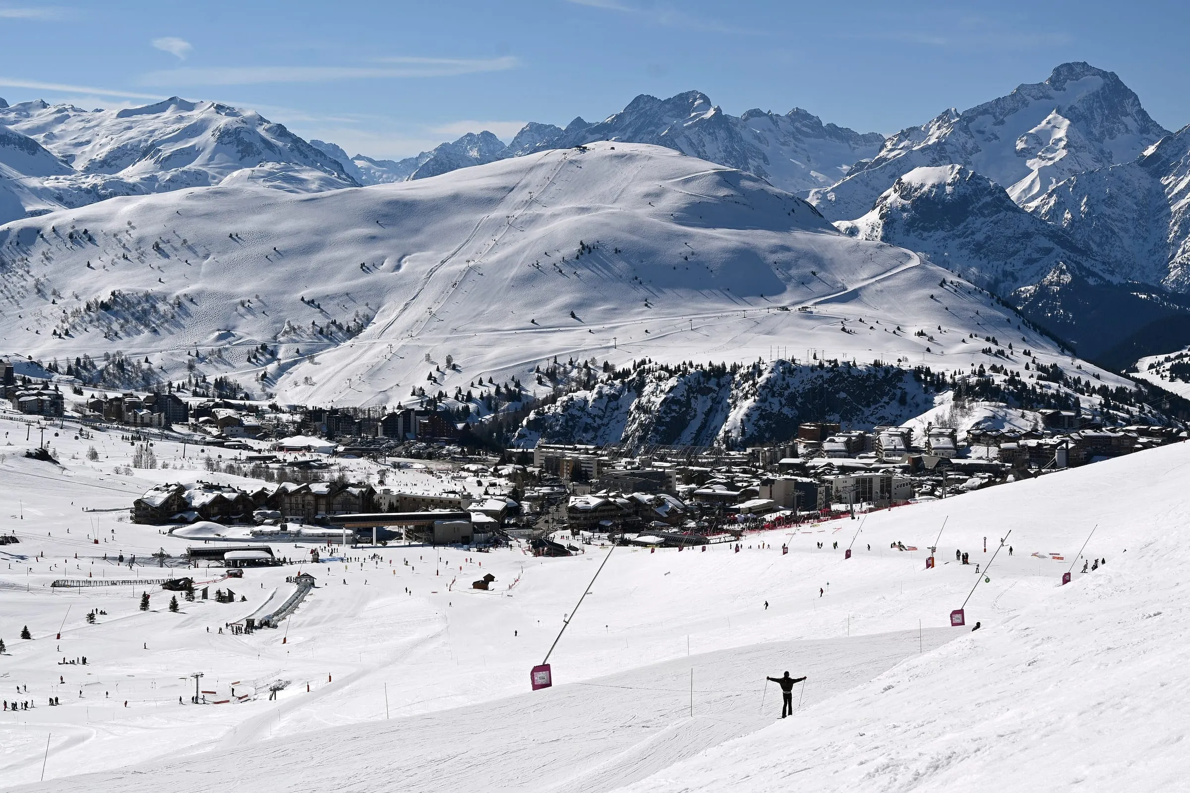 Wide pistes above Alpe d'Huez with the Écrins peaks behind