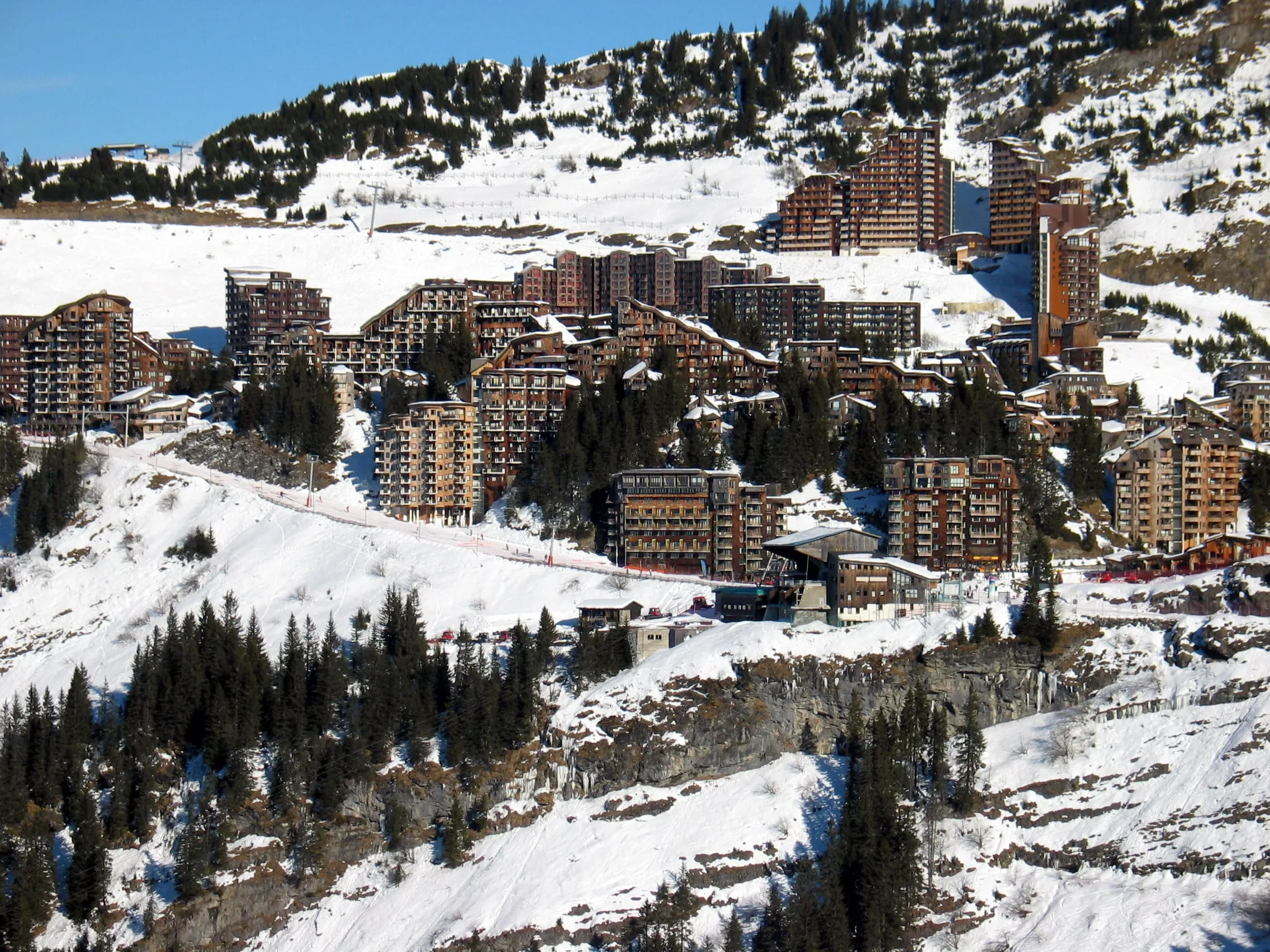 Avoriaz's wood-clad apartment buildings in the snow above the forest