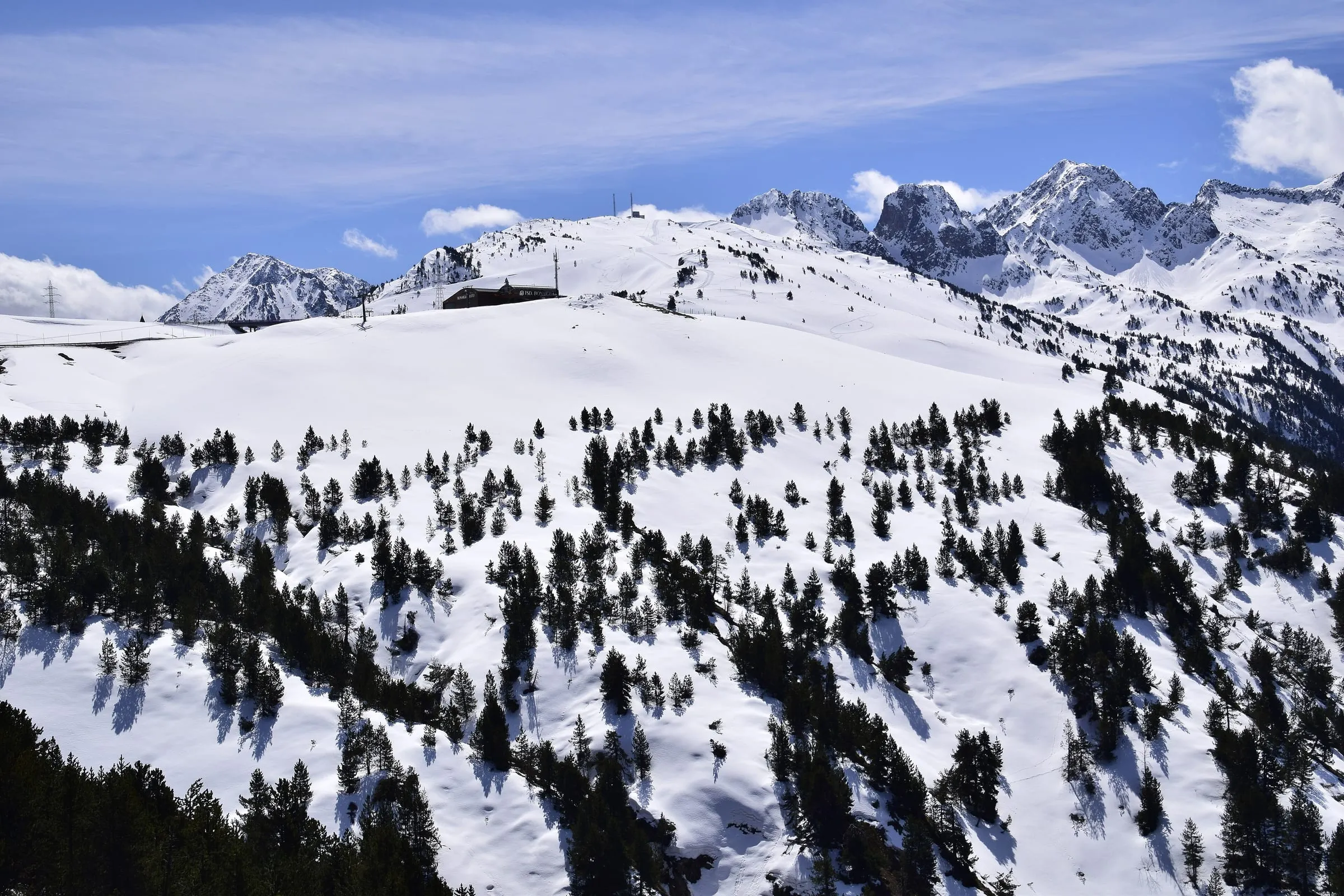 Snow-covered slopes and forest around the Port de la Bonaigua pass in the Pyrenees