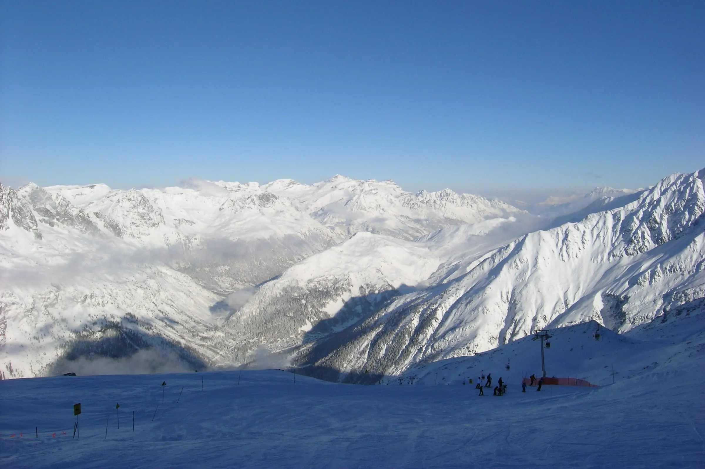 Skiers on the snowy slopes of the Grands Montets ski area above Argentière