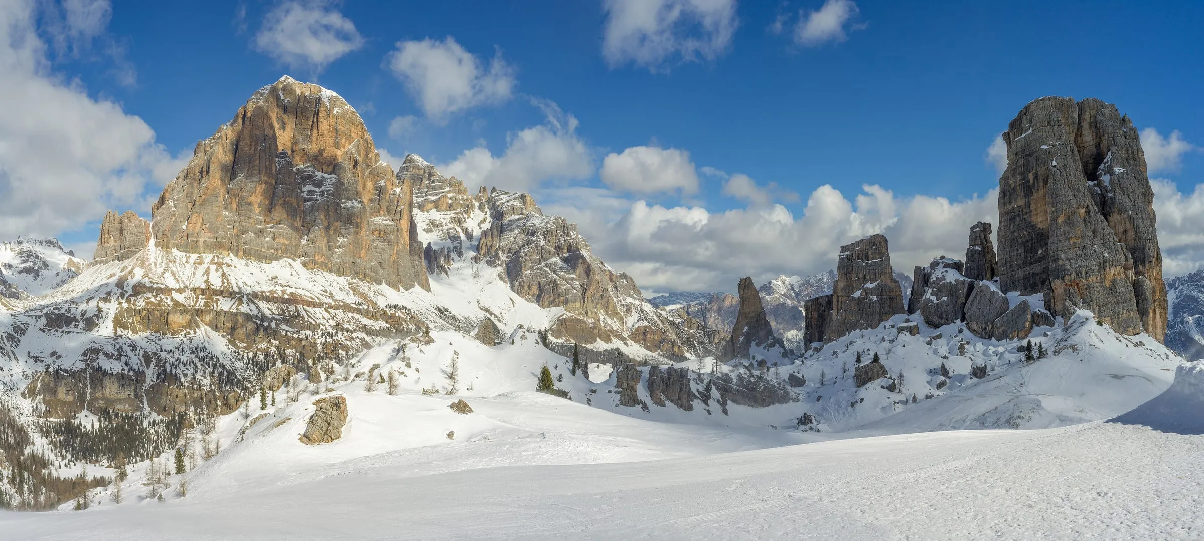 Pistes in the Cinque Torri ski area near Cortina d'Ampezzo, with the Tofana di Rozes behind