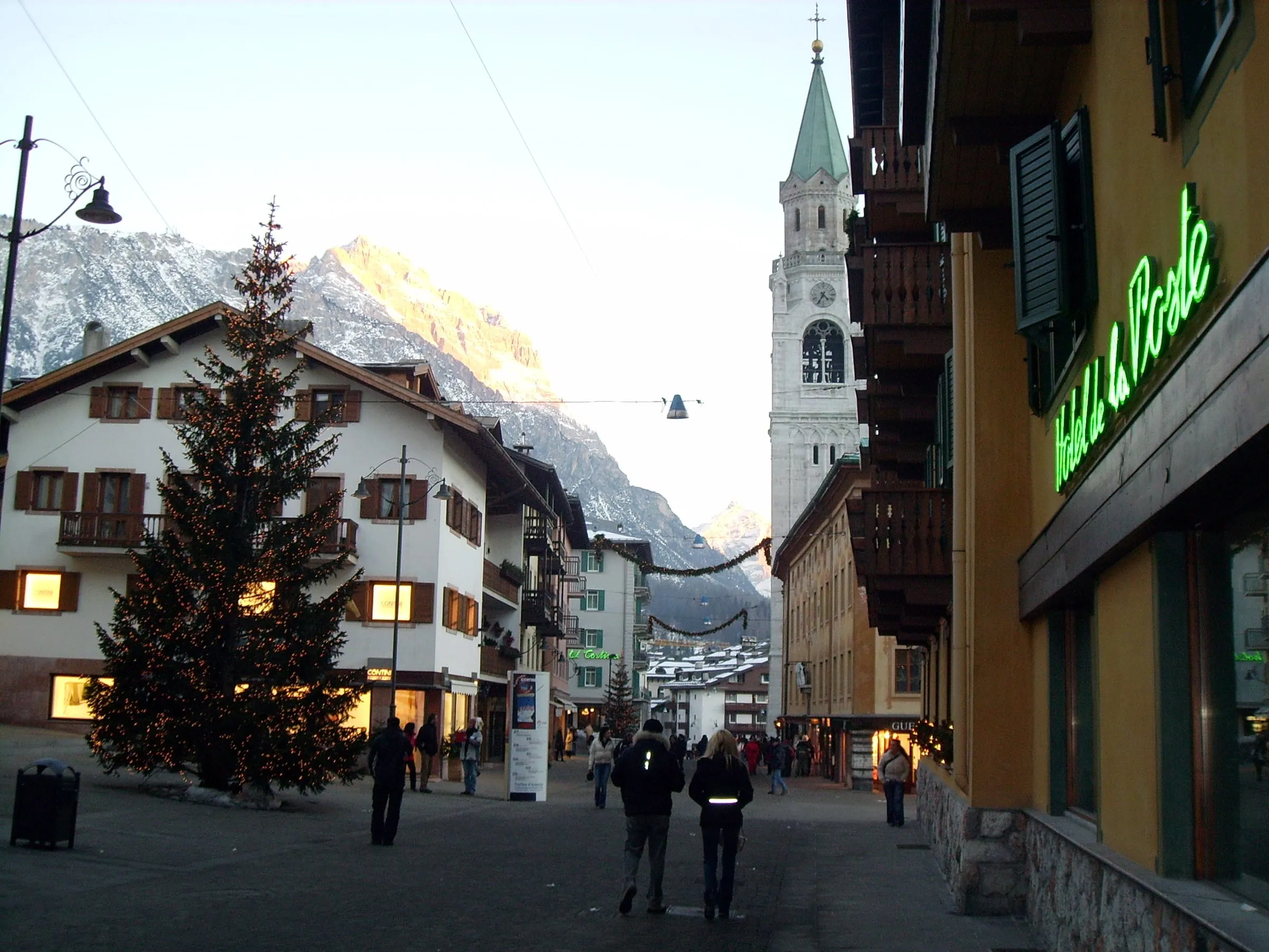 Corso Italia in Cortina d'Ampezzo in winter, with a Christmas tree and the bell tower