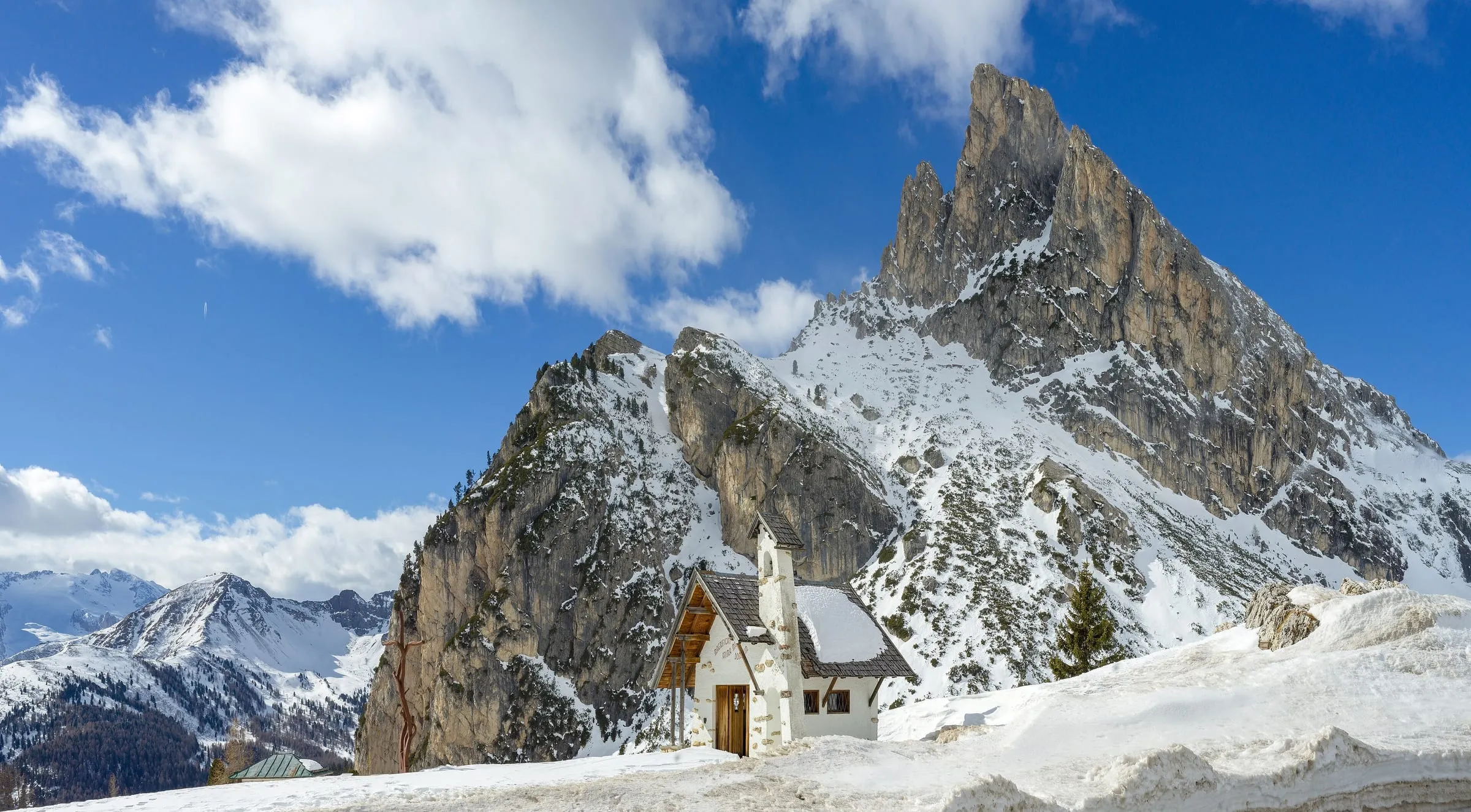 The small chapel on the snowy Falzarego Pass near Cortina, below the Sass de Stria