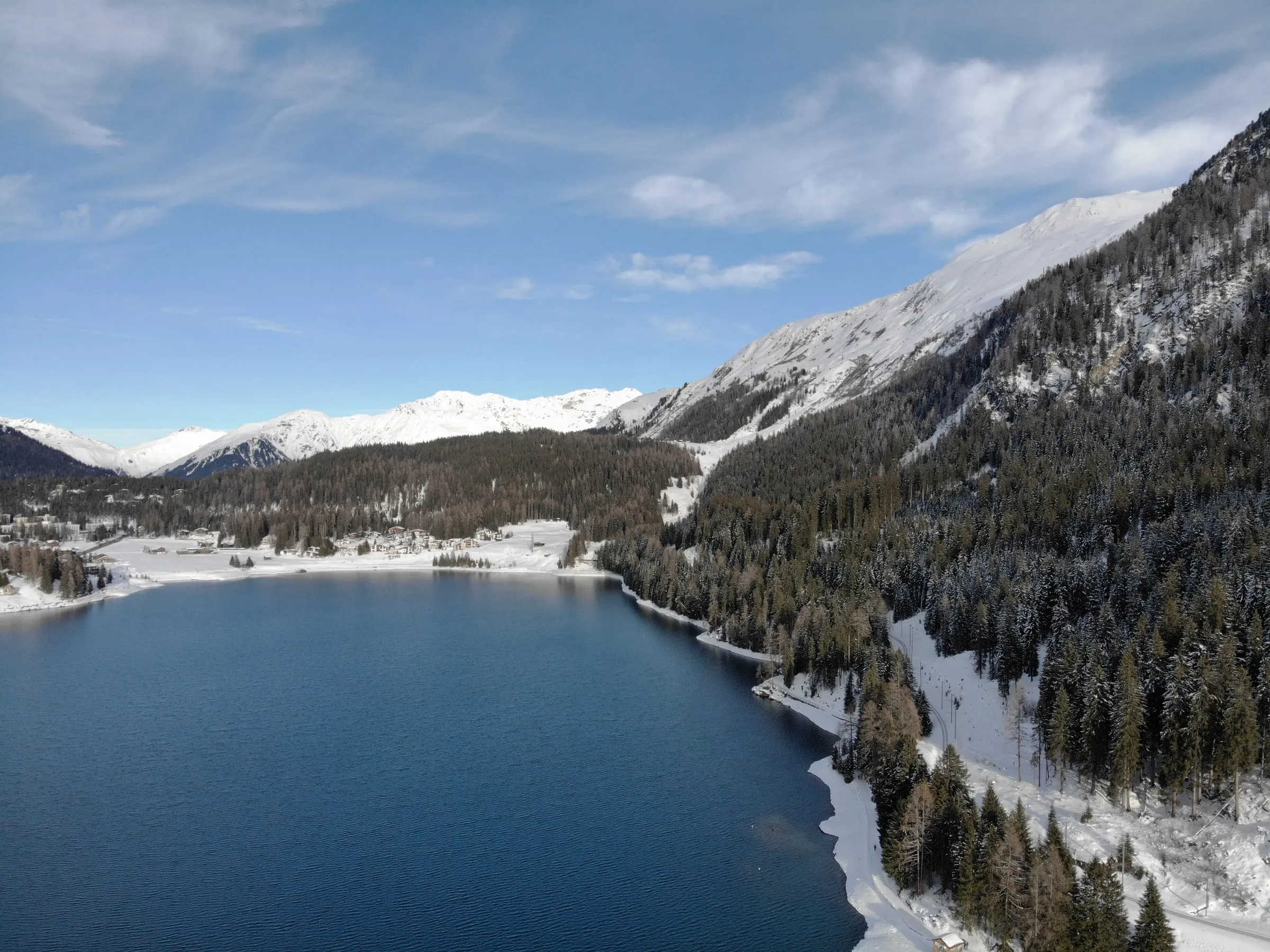 Lake Davos in December, with snow-covered mountains rising above the valley