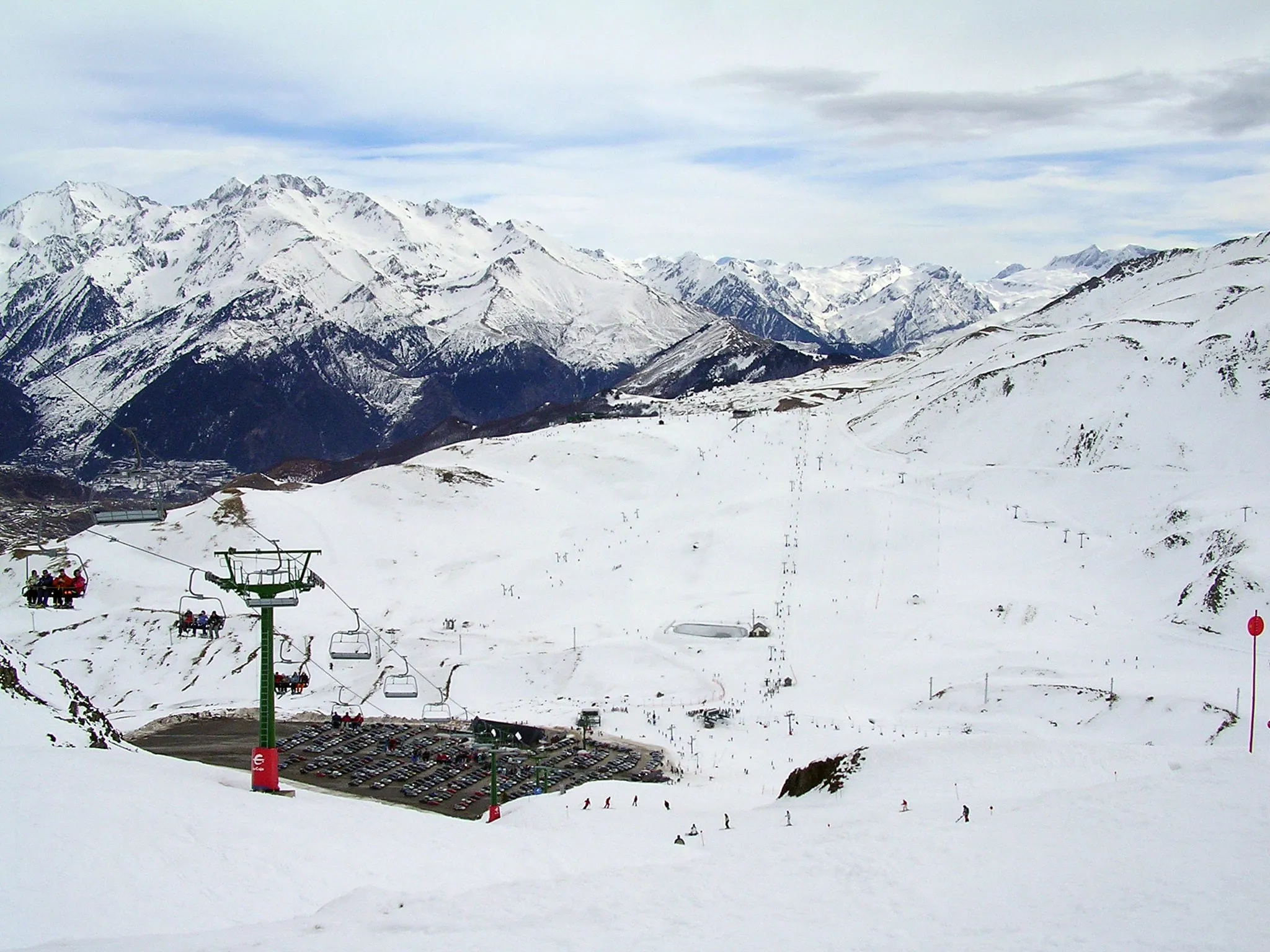 The Formigal ski area in winter, with pistes, a chairlift and snowy Pyrenean peaks behind