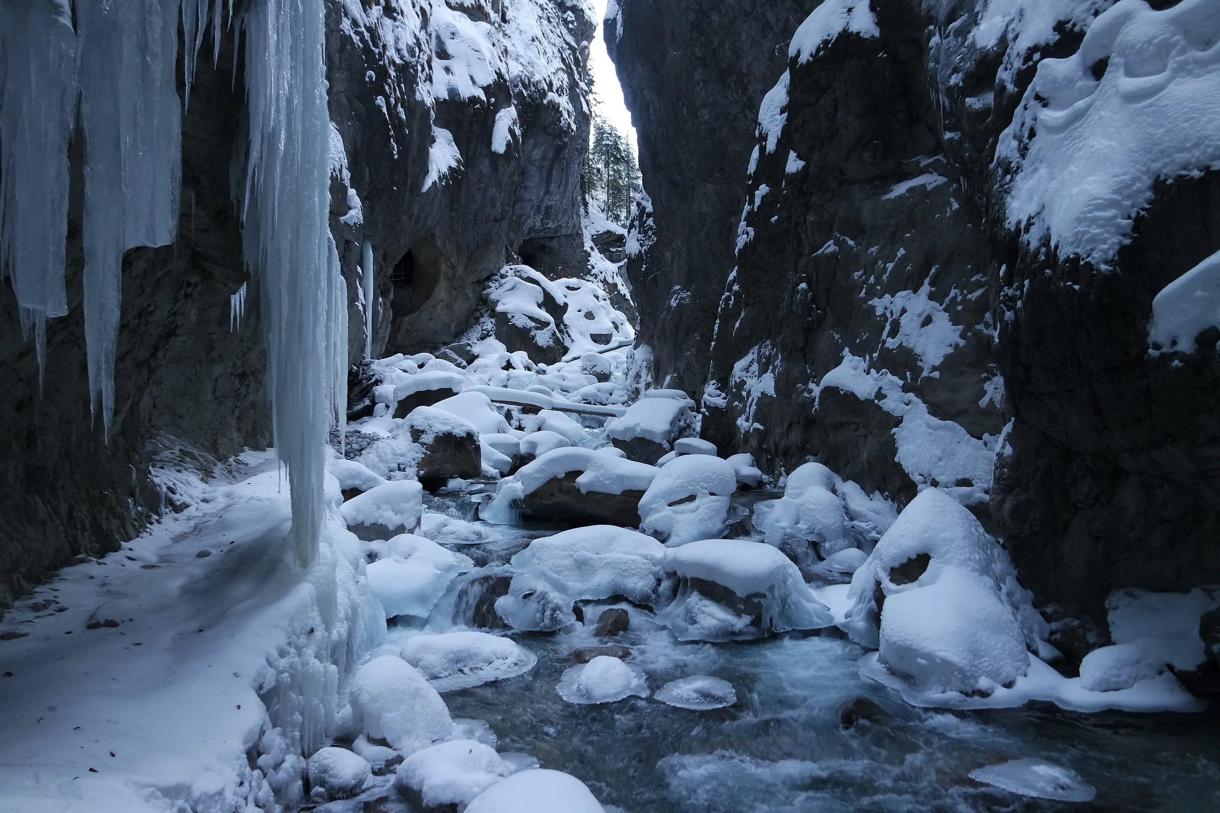 Icicles and snow-covered boulders in the Partnach gorge near Garmisch-Partenkirchen in winter