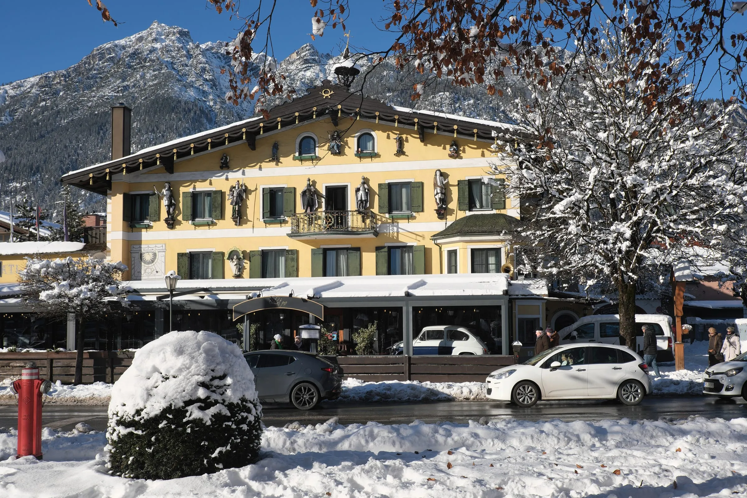 The painted facade of the Posthotel on Marienplatz in Garmisch, in the snow