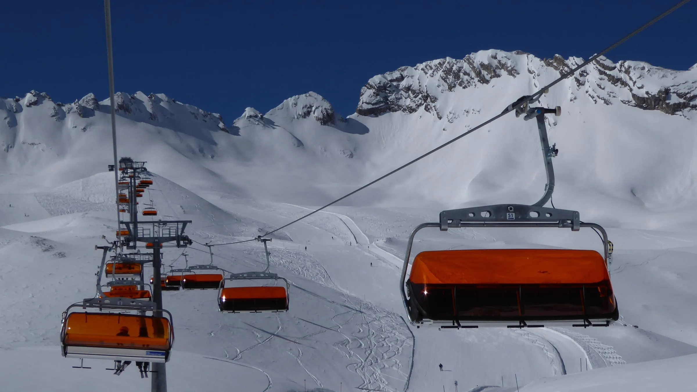 Orange-hooded chairlift over the snowy Zugspitzplatt ski area in March