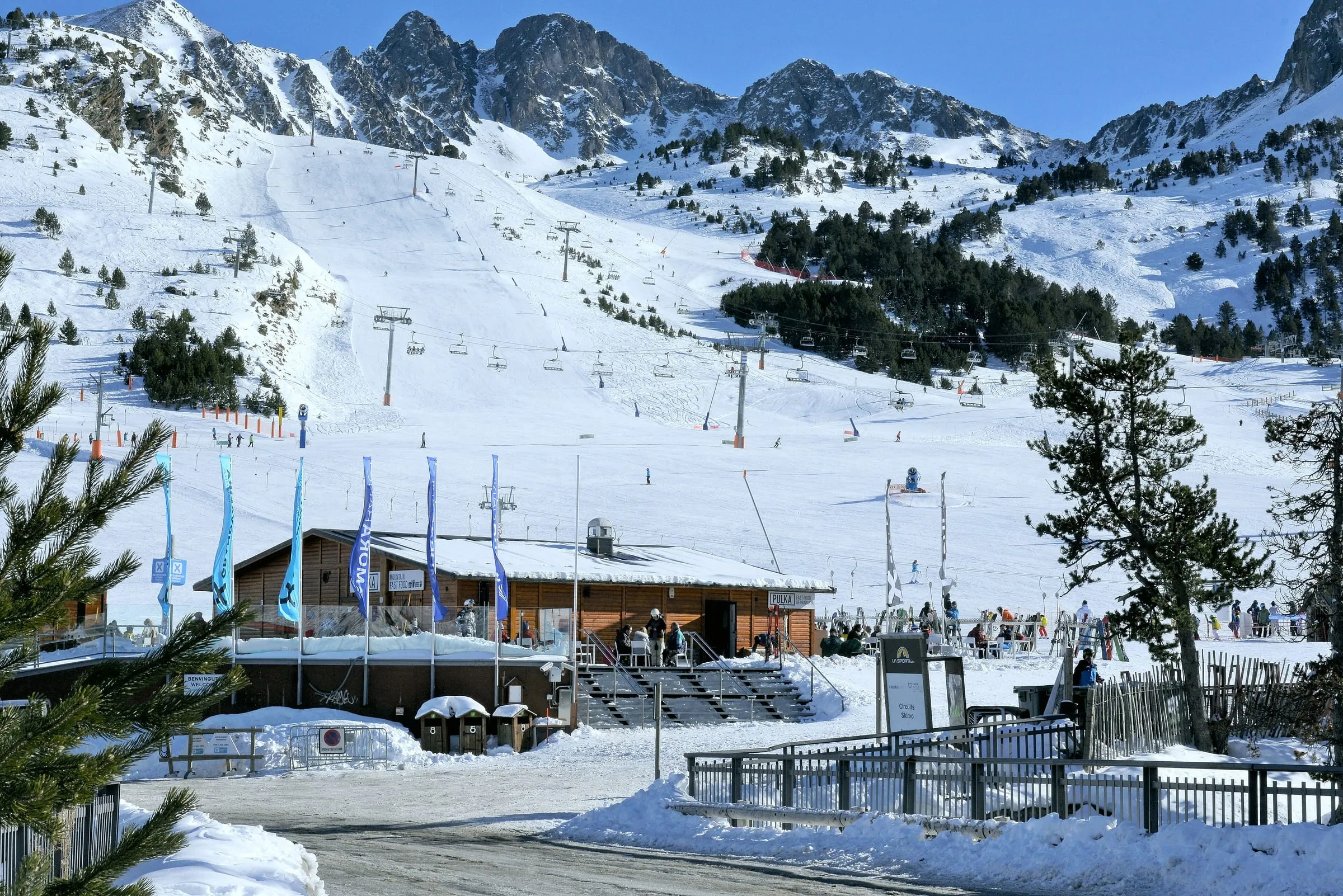 Ski lifts and pistes above the Grau Roig base area in Grandvalira, with the Pessons peaks behind