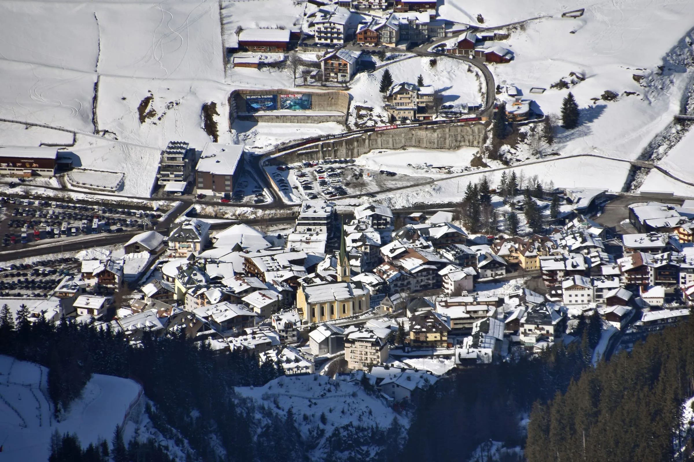 Snow-covered rooftops of Ischgl village in the Paznaun valley, seen from above