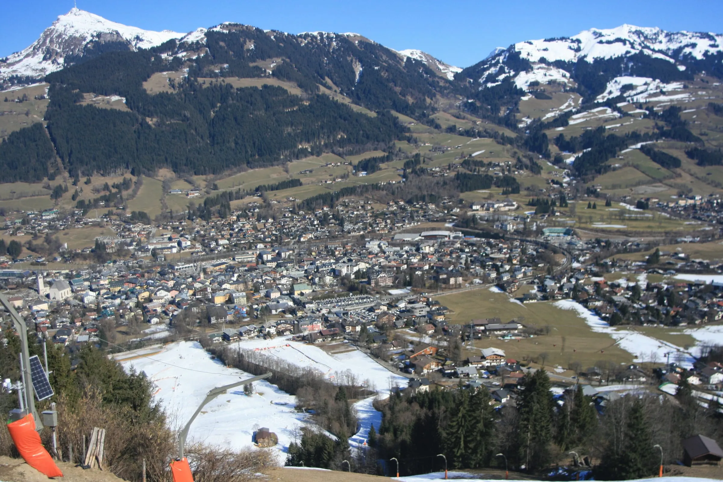 Kitzbühel and its valley seen from the ski slopes, with snow on the higher ground