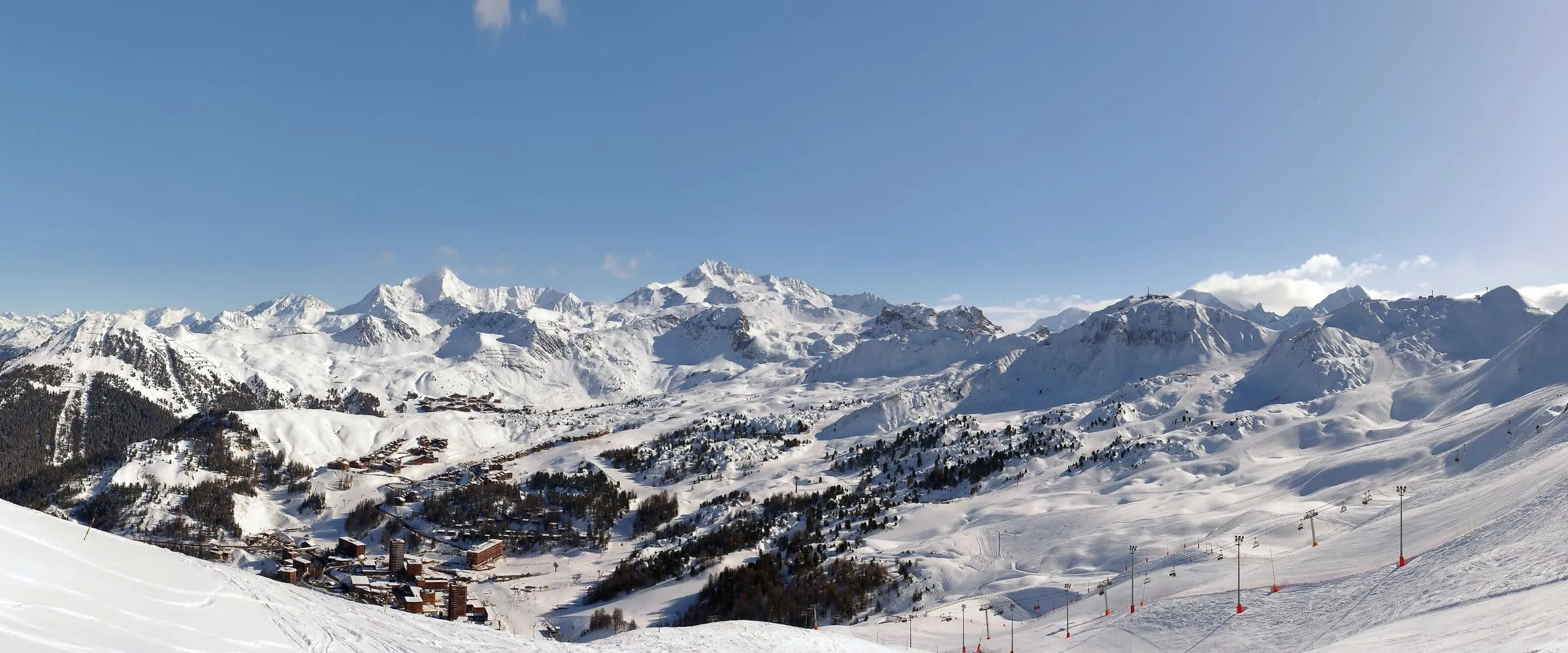 Panorama of the La Plagne ski area in winter, with snowy peaks on the horizon