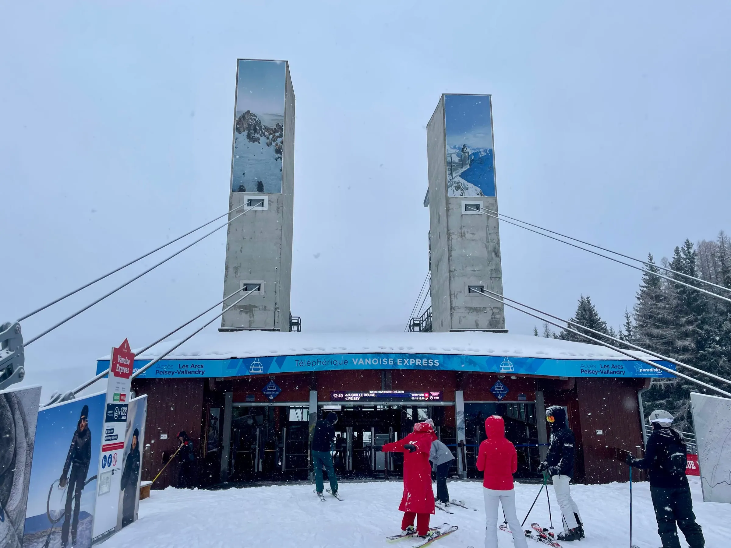 Skiers outside the Vanoise Express cable car station on the La Plagne side