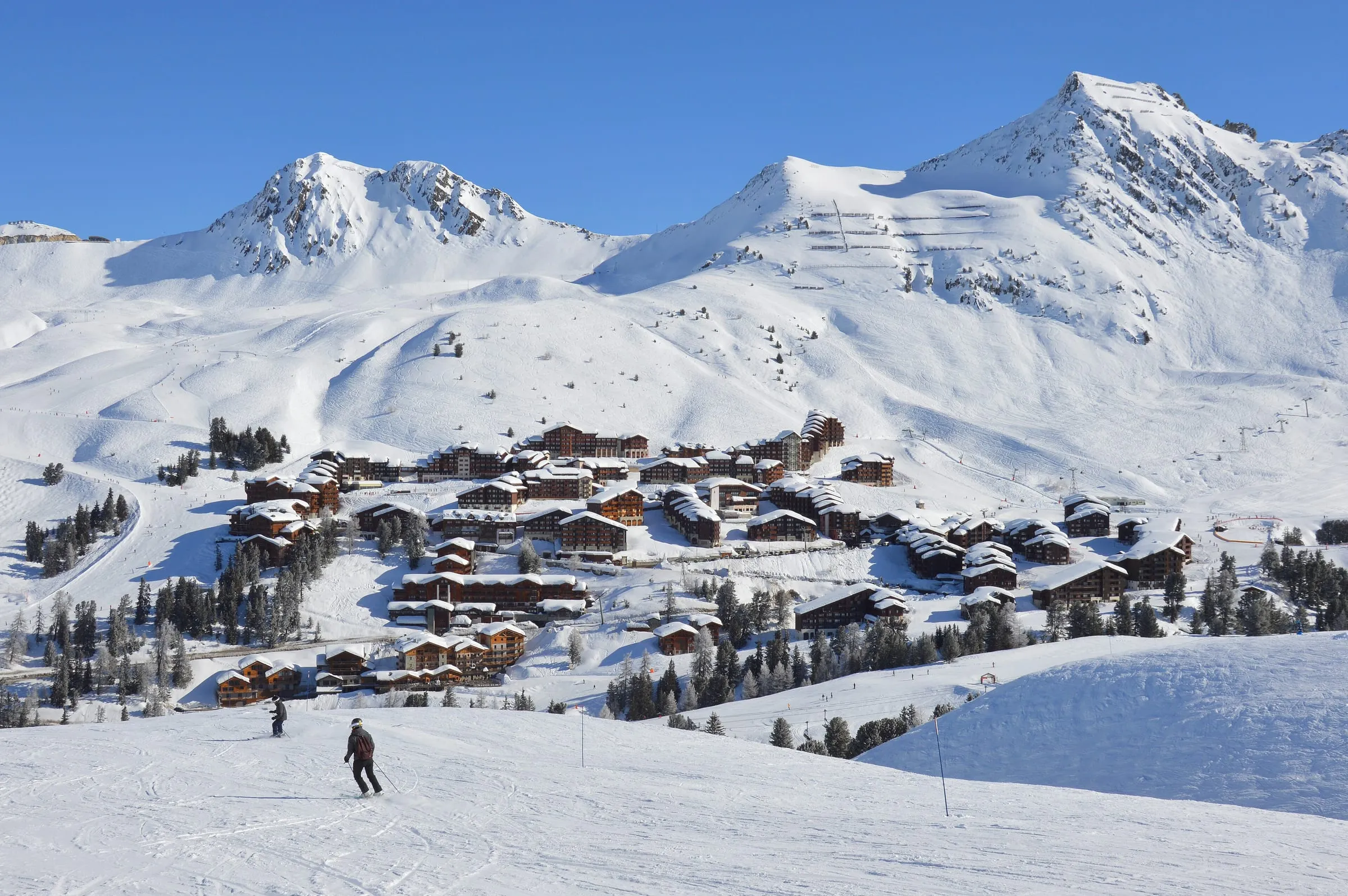 Belle Plagne in the snow below sunny peaks, seen from the Colosses piste