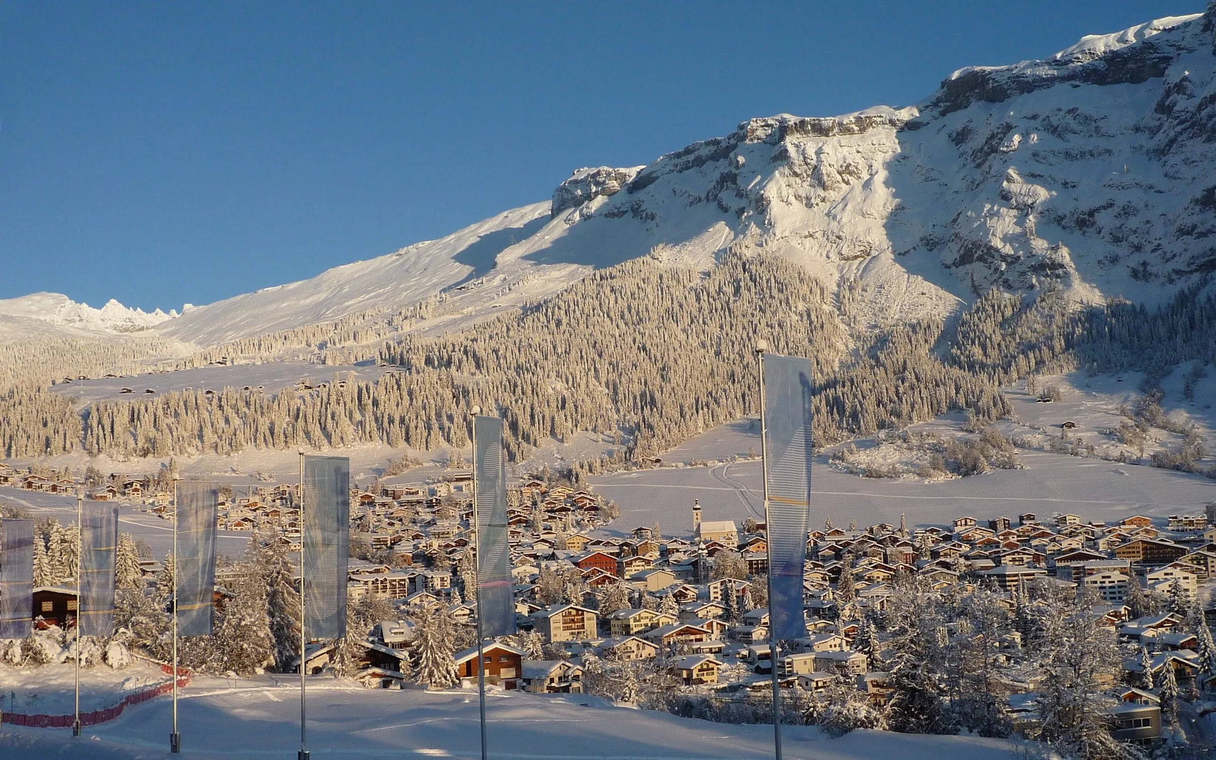 Flims in early-winter snow, seen from the promenade in Flims Waldhaus, with the Flimserstein above