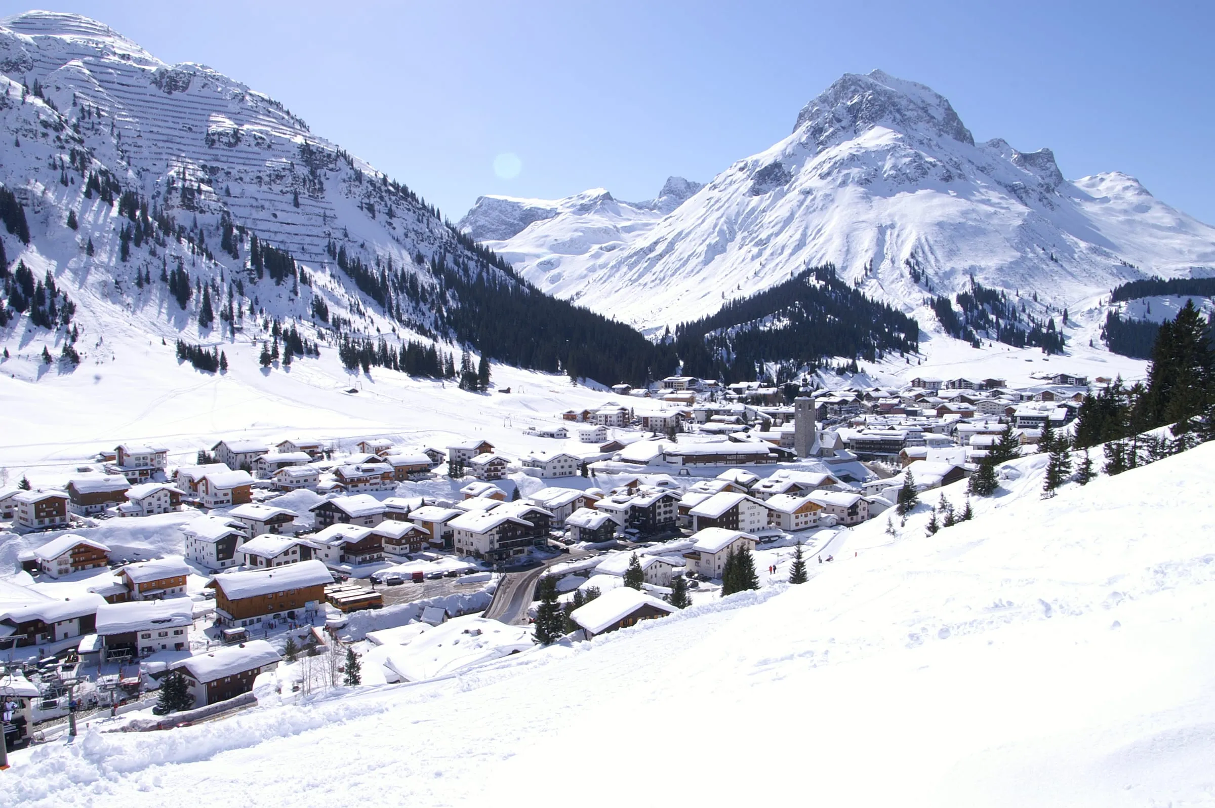 Lech am Arlberg in deep winter snow, with the Omeshorn rising above the village