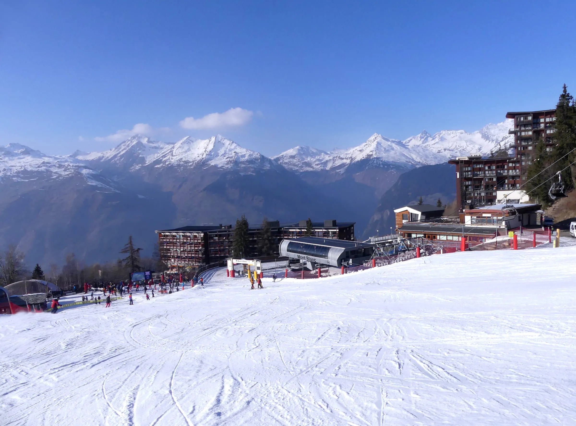 The snow front at Arc 1600, with the village buildings and mountains across the valley