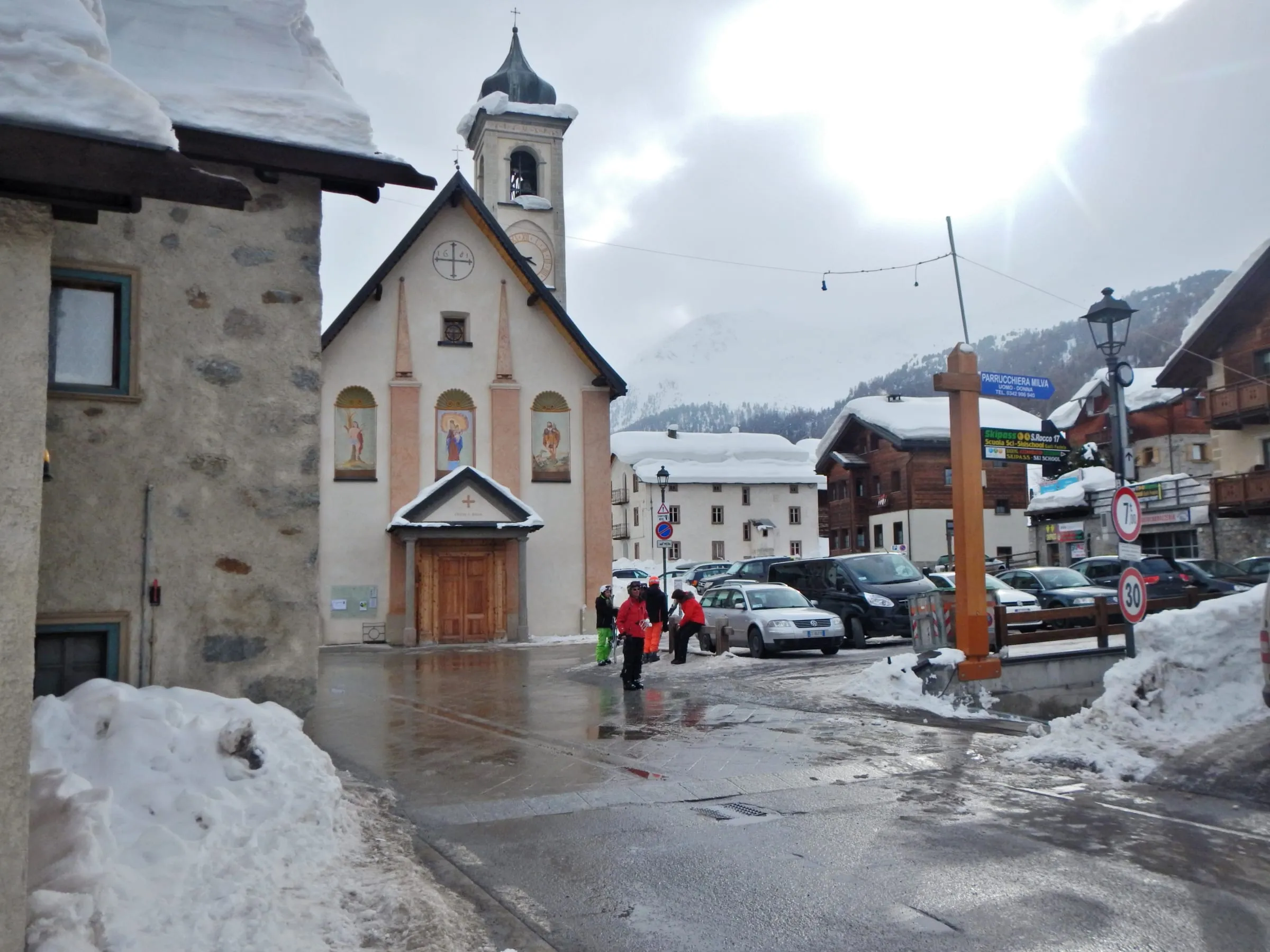 A church and houses in the centre of Livigno after snowfall