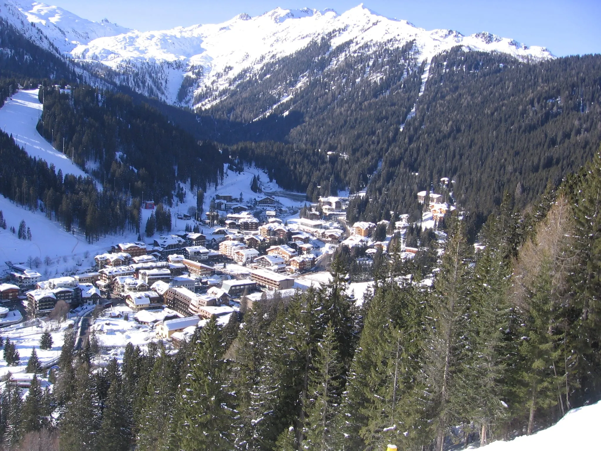 Madonna di Campiglio village in its wooded valley in winter, seen from the east