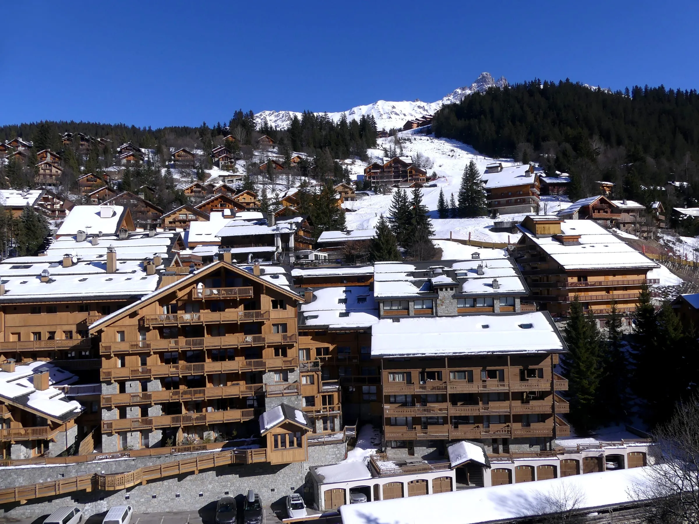 Chalet-style buildings of Méribel centre in the snow, seen from the Olympe gondola
