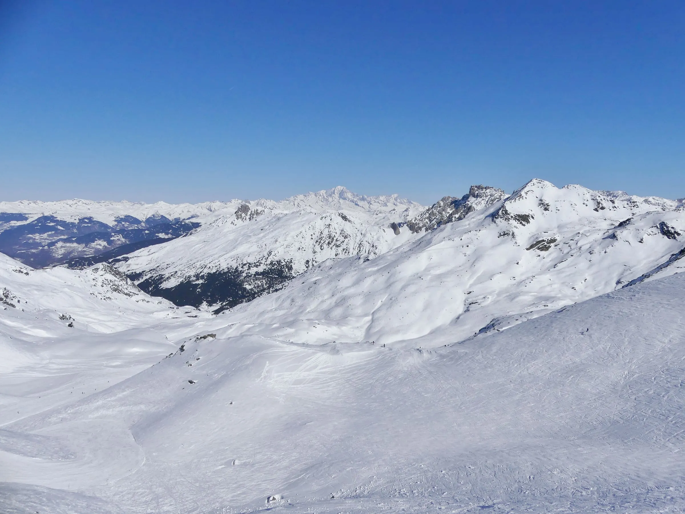 The open, snowy upper slopes of the Méribel valley seen from the Col de la Chambre
