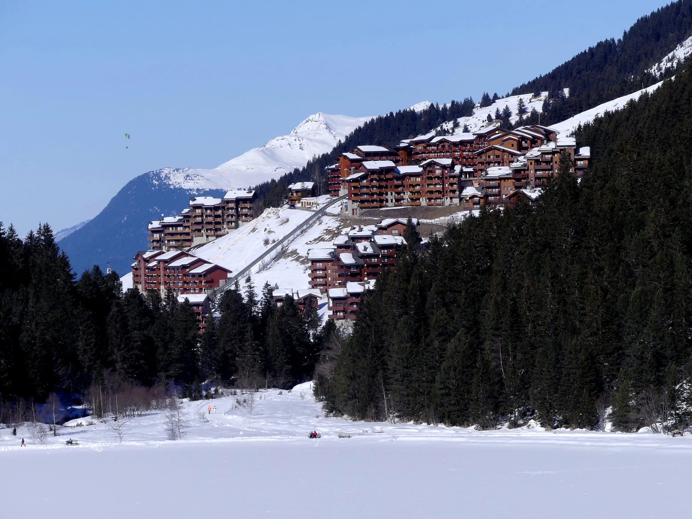 Méribel-Mottaret seen across the frozen Lac de Tuéda, with forest around