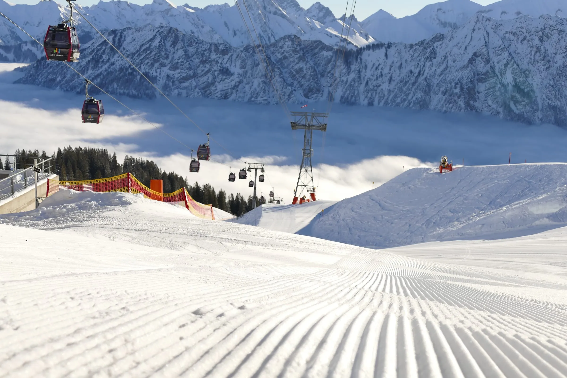 Groomed pistes on the Fellhorn above Oberstdorf, with the Fellhornbahn gondola and snowy Allgäu peaks