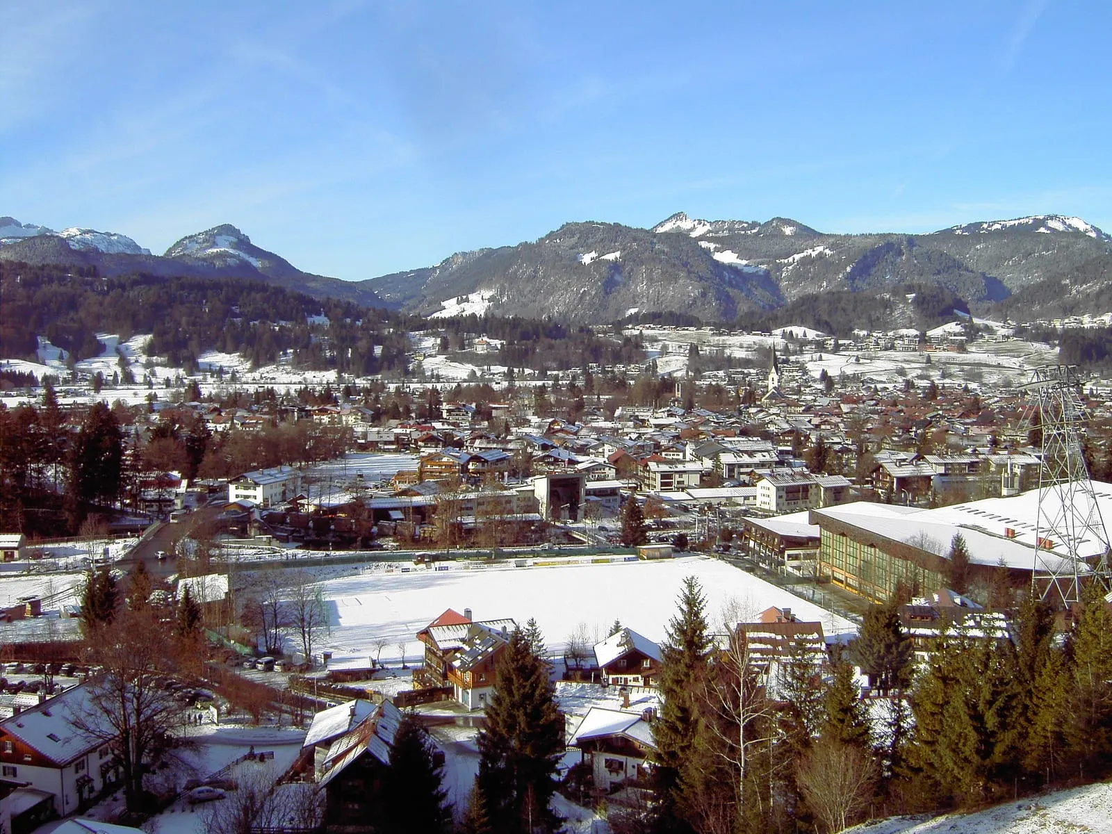 Oberstdorf's rooftops in winter with the snowy Allgäu mountains behind