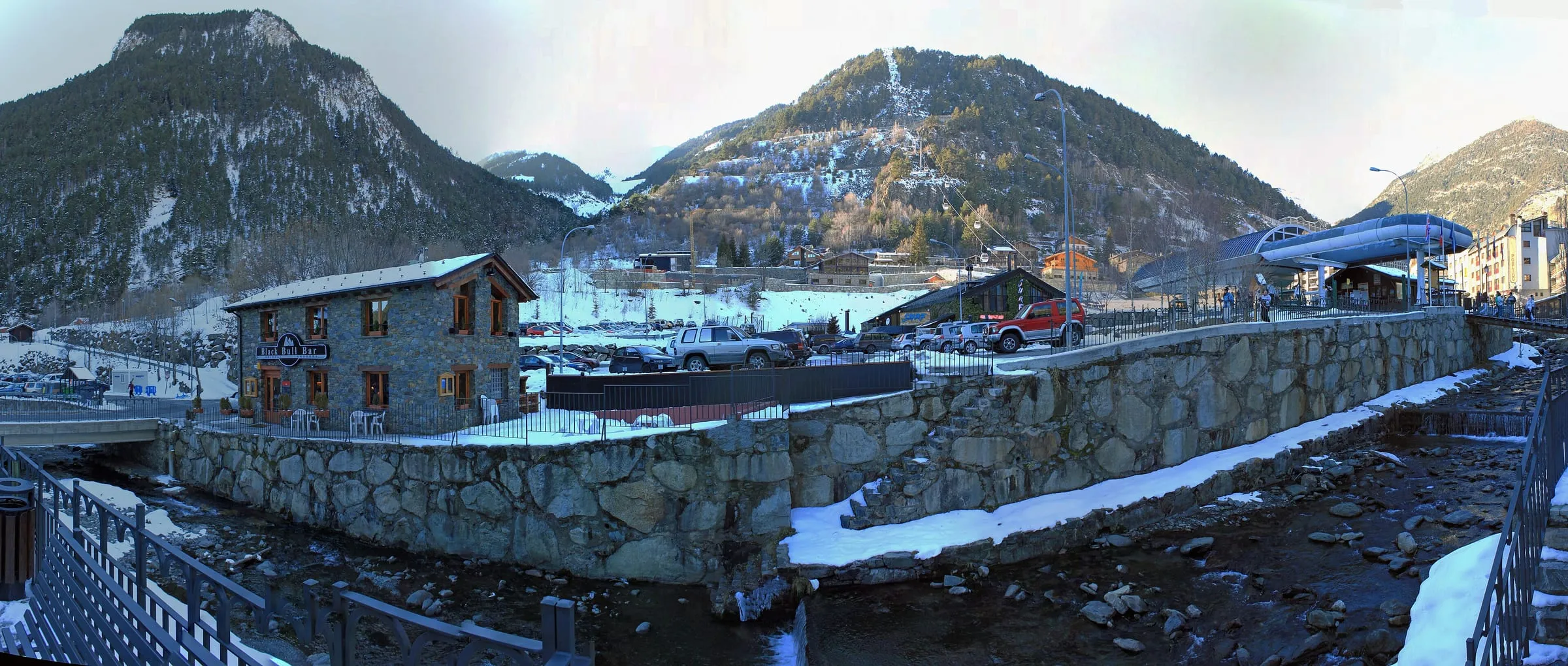 Arinsal village in winter, with the gondola station on the right and the mountains behind