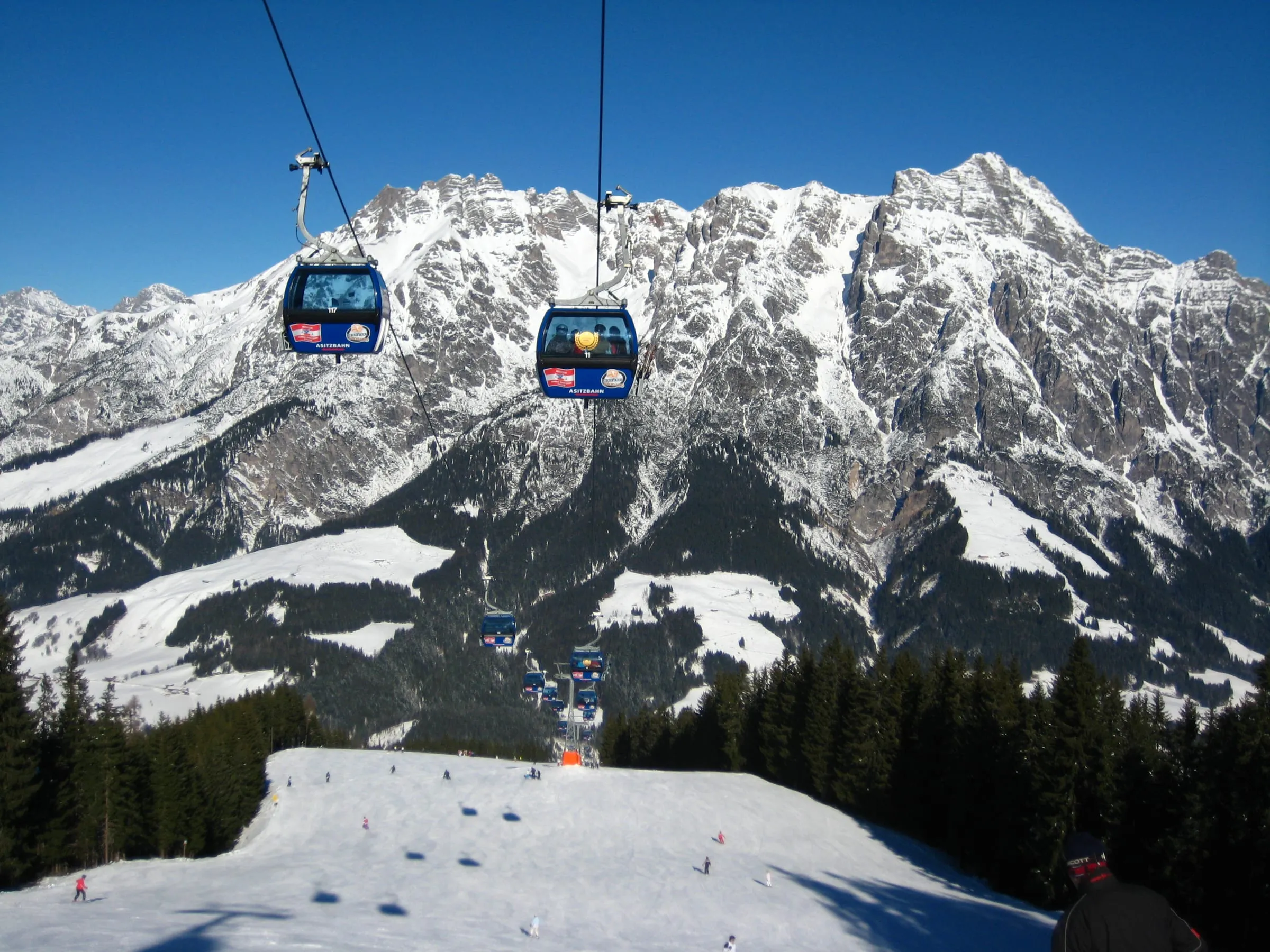 Gondolas on the Asitz above Leogang with the snowy Leoganger Steinberge range behind