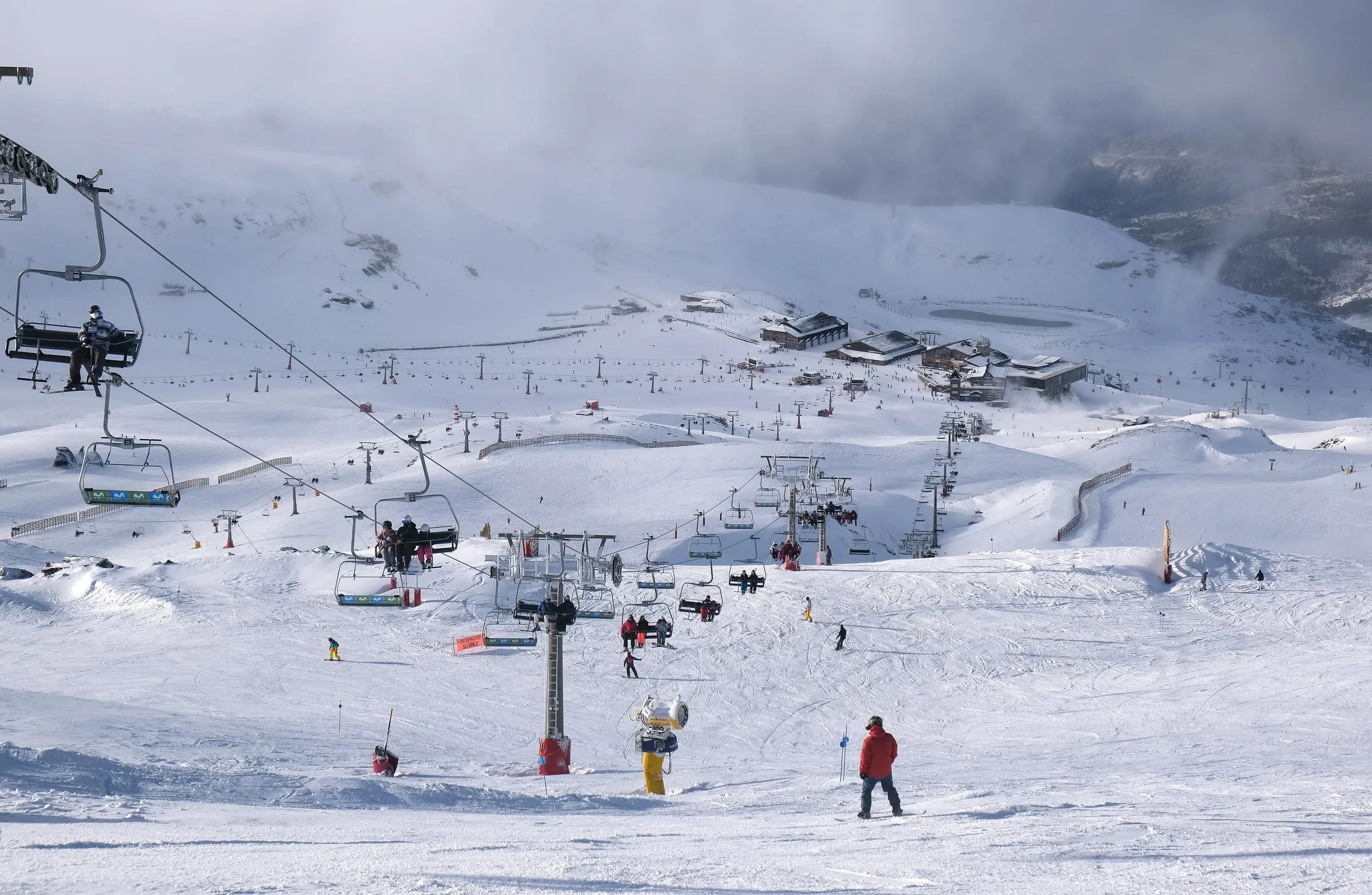 Skiers, chairlifts and beginner slopes at Borreguiles in Sierra Nevada