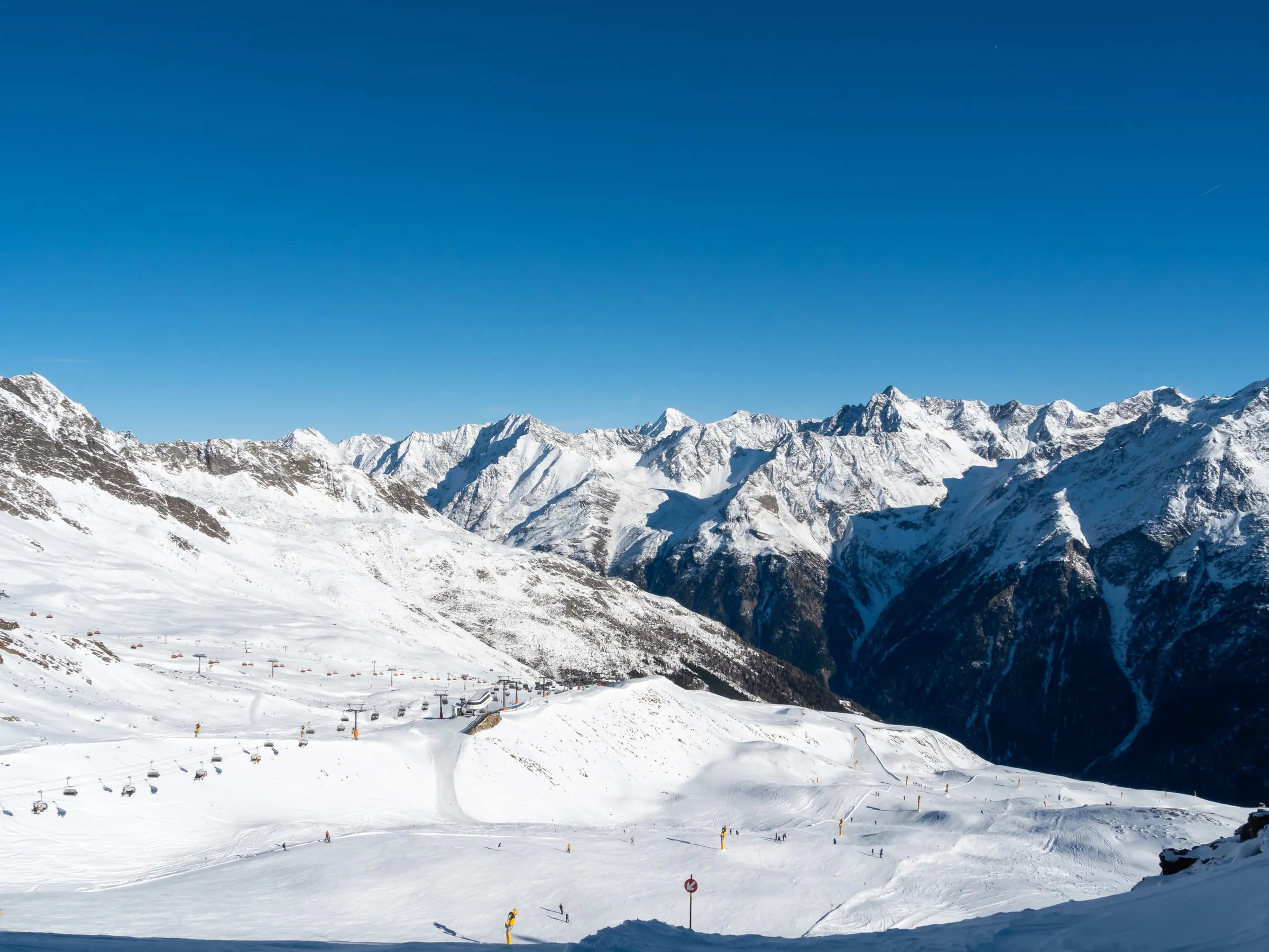 Wide pistes in the Sölden ski area seen from the Rotkoglhütte, with the Stubai Alps behind