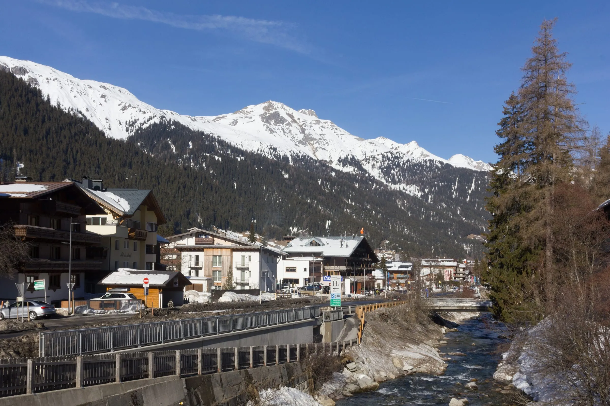 Chalets and hotels beside the Rosanna river in St. Anton am Arlberg in winter