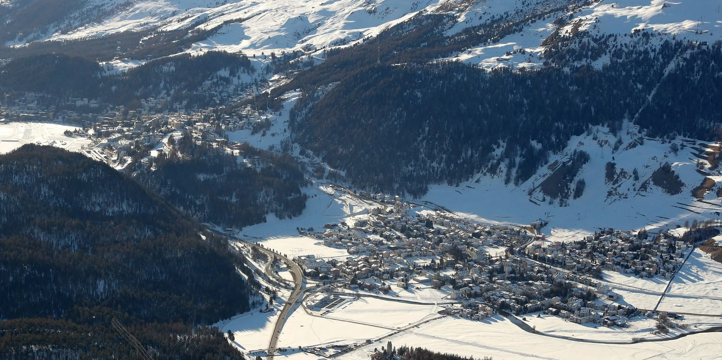 Celerina in winter seen from Muottas Muragl, with St. Moritz further up the valley