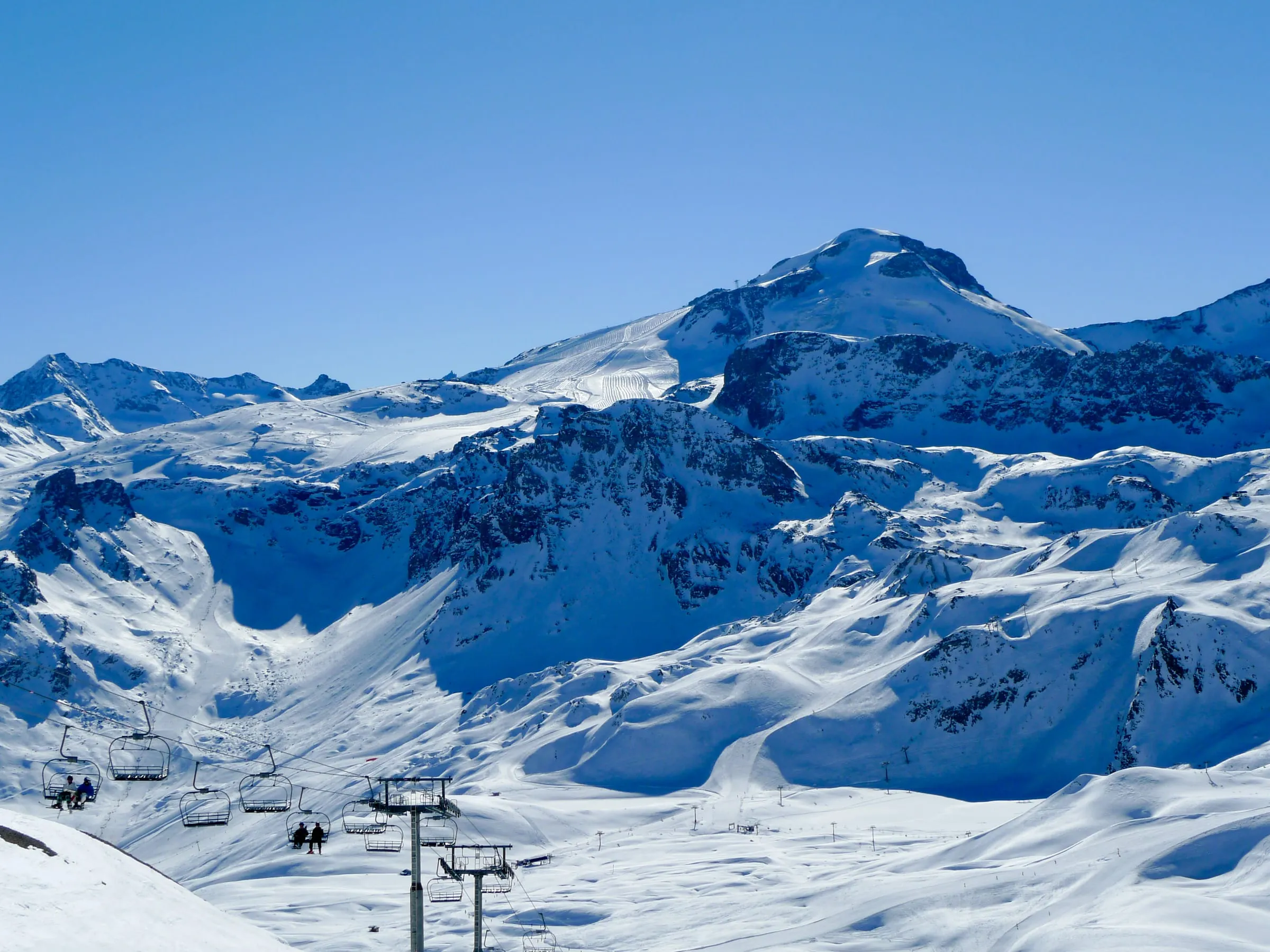 Snowy ski slopes and lifts below the Grande Motte in Tignes, seen from the Aiguille Percée