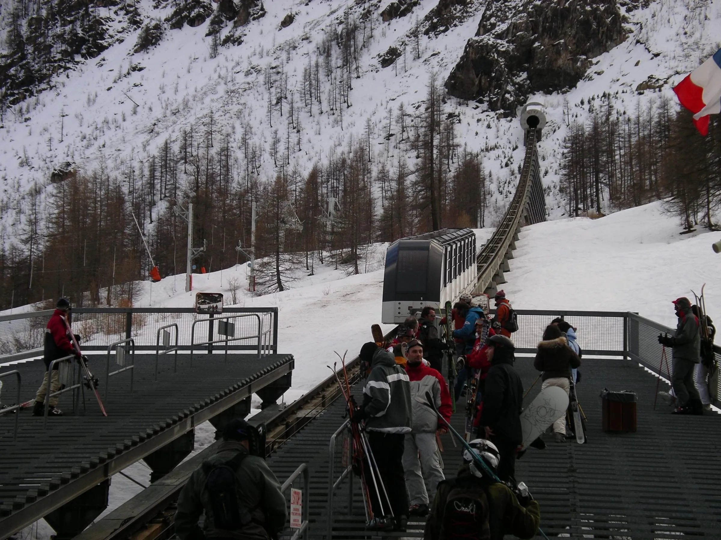 Skiers boarding the Funival underground funicular at La Daille in Val d'Isère