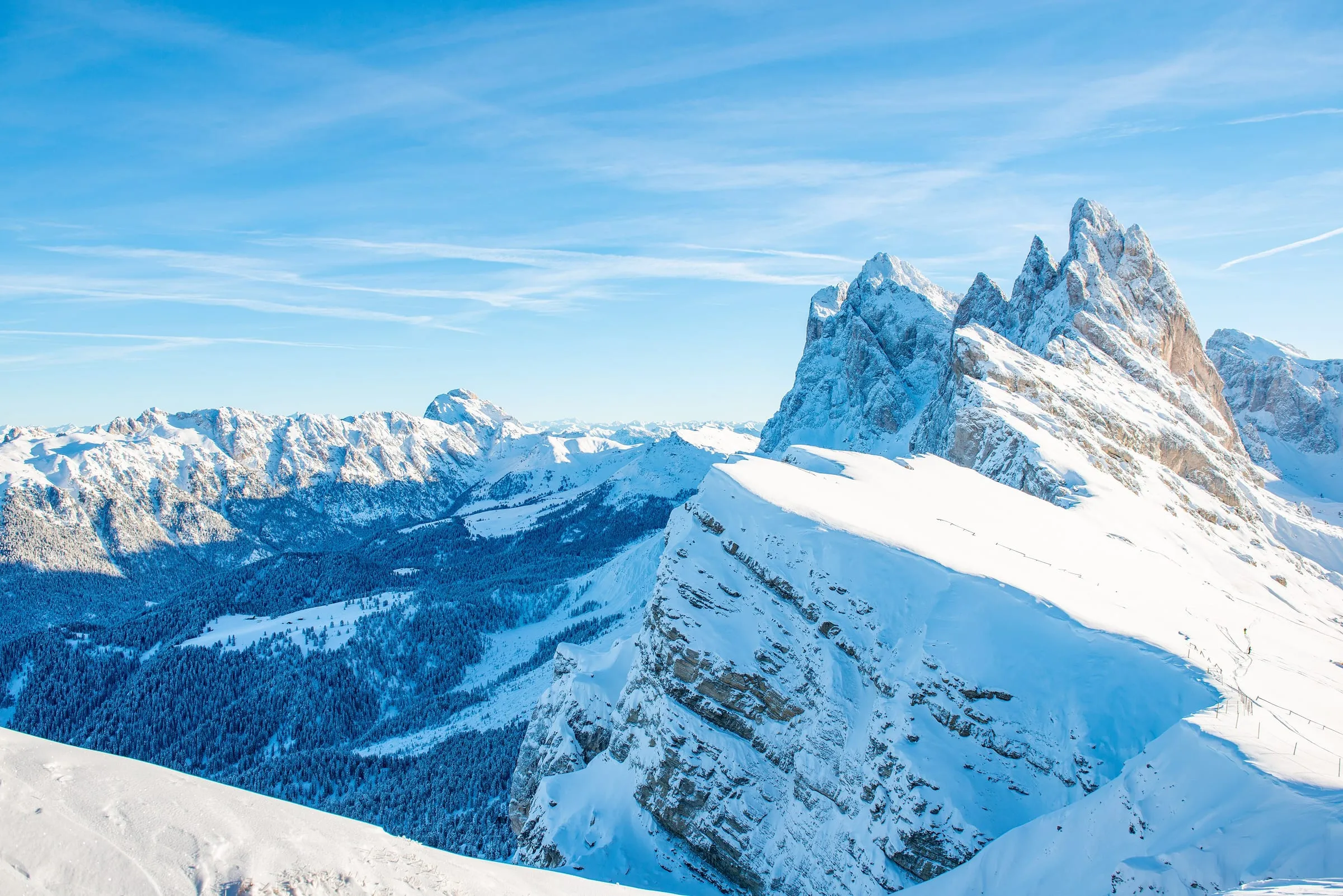 The Seceda ski area in winter with the jagged Odle peaks behind, above Ortisei in Val Gardena