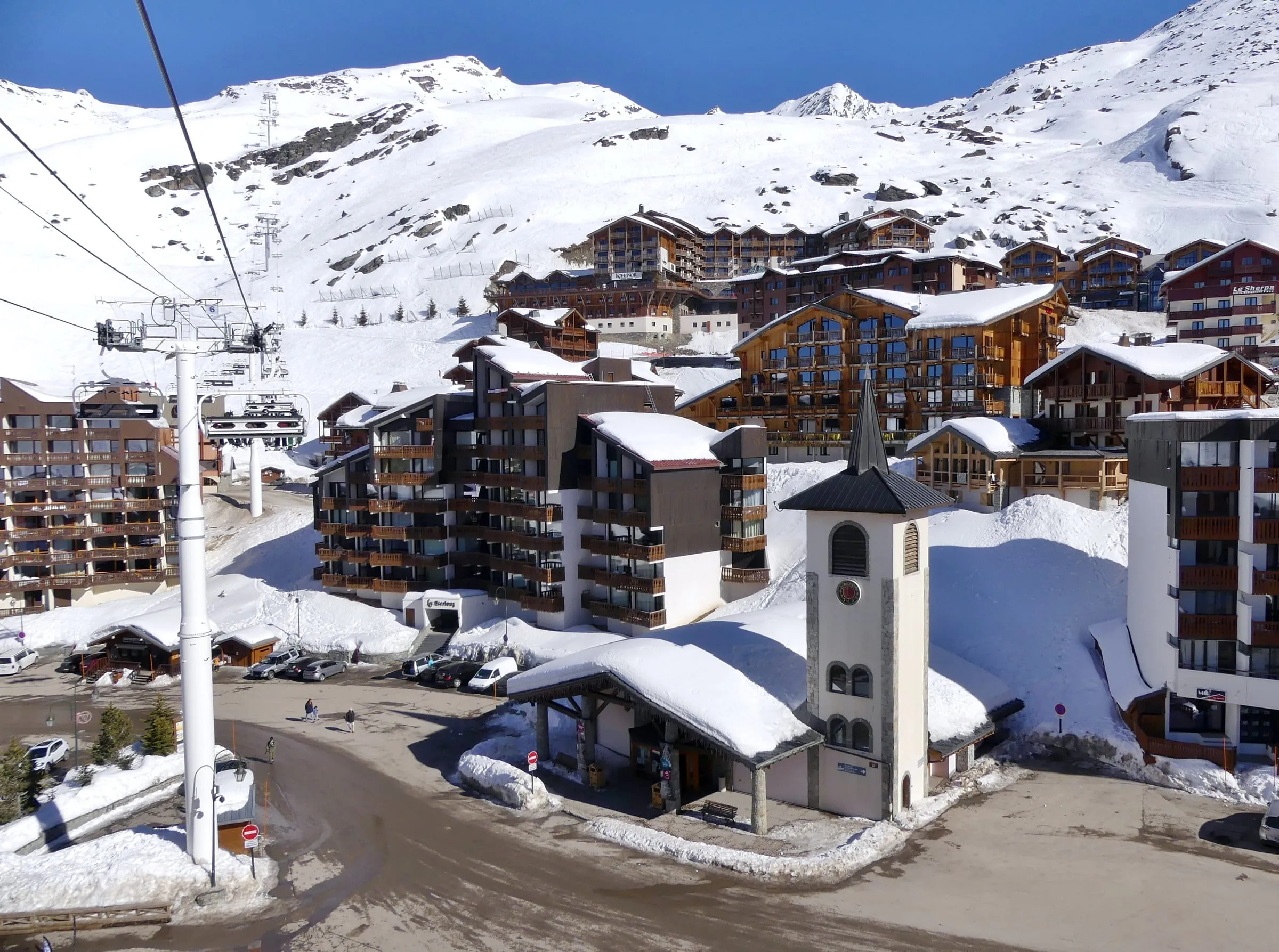 Val Thorens chapel and apartment buildings in the snow, seen from a chairlift