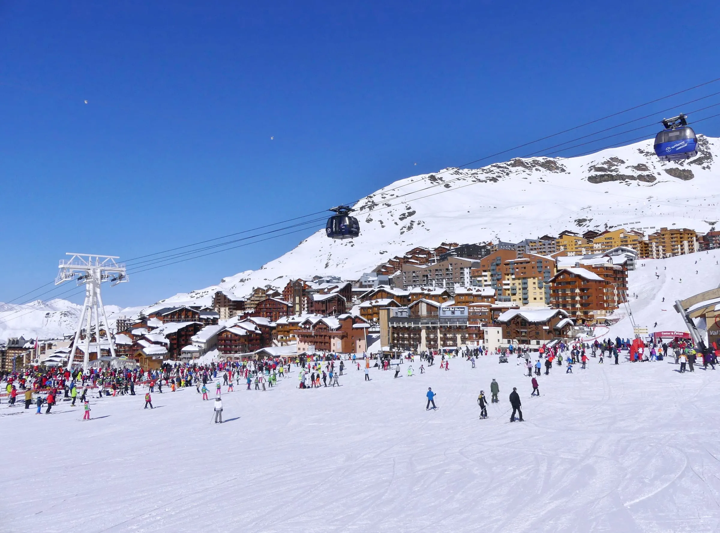 Skiers at the foot of the pistes in Val Thorens, where the main runs meet the village