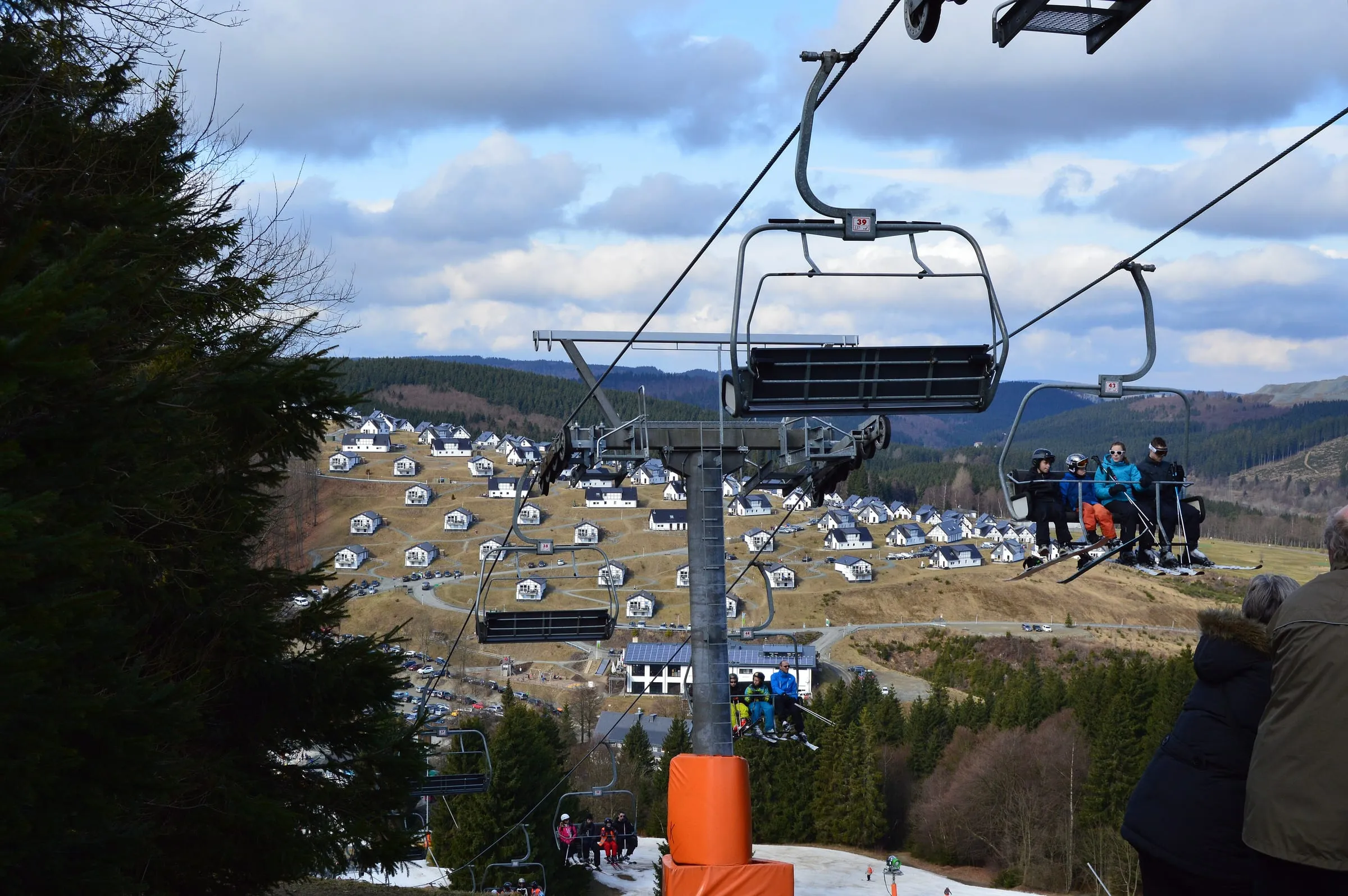 View from a chairlift over the Winterberg slopes towards the holiday homes below
