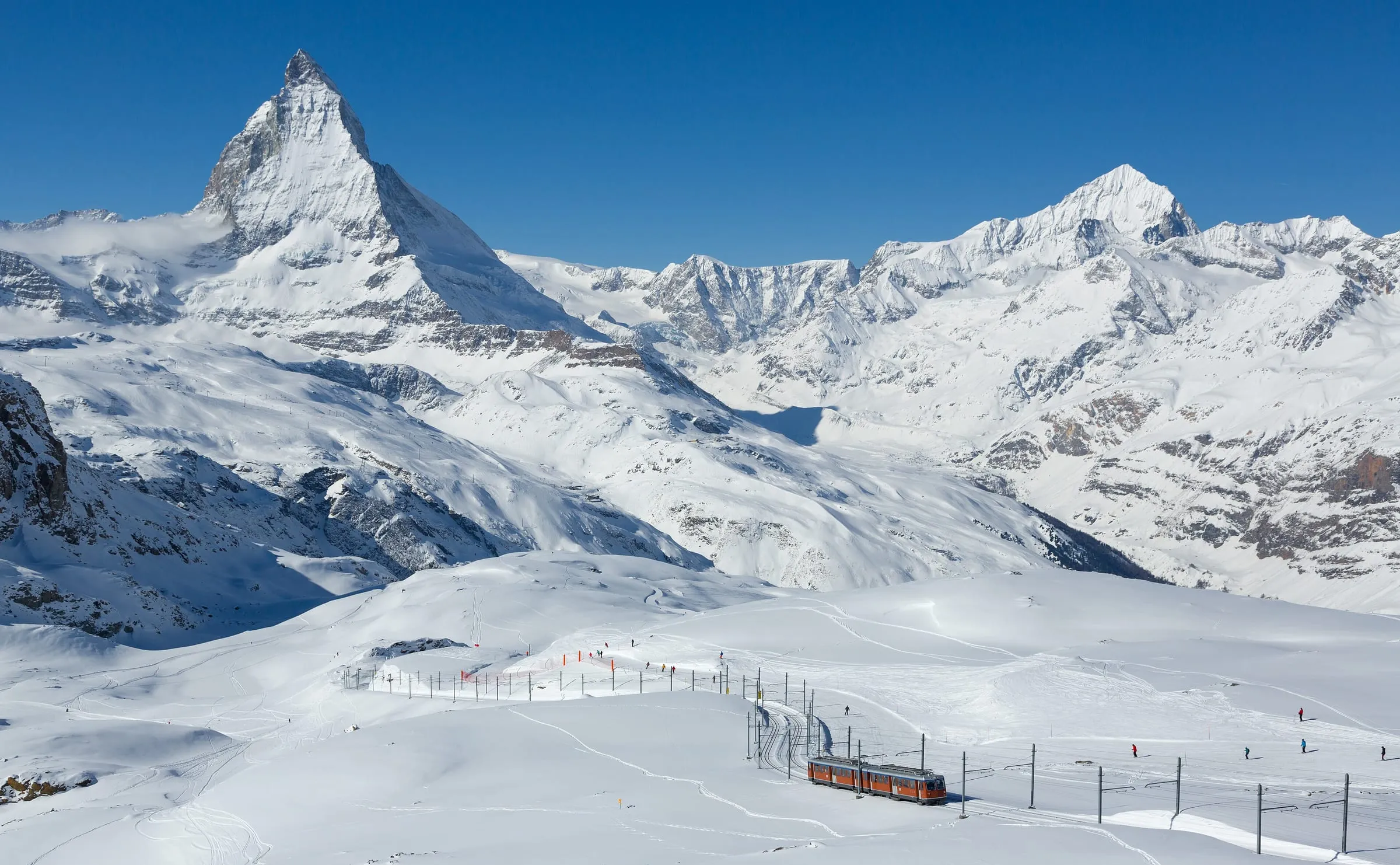 Gornergrat railway train crossing snowy ski slopes between Rotenboden and Gornergrat, with the Matterhorn behind